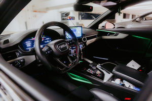 Lifestyle inspiration: blue automotive ambient lighting, not a verified photo of the included RAYSHIFT kit